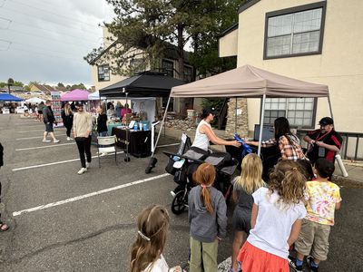 Shoppers browsing vendor booths at a SideQuest Events market