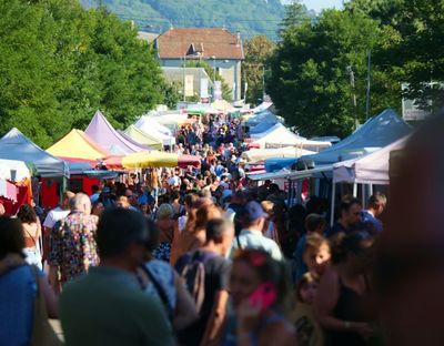 Large crowd of people browsing through vendor tents at a SideQuest Events-organized fair