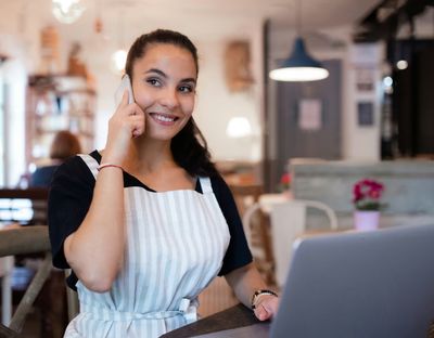 Small business owner in the Denver Metro Area on the phone with SideQuest Events, discussing VIP Membership as an event vendor