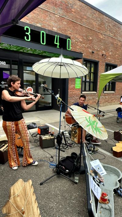 Musicians performing at a SideQuest Events summer fair in Denver, Colorado
